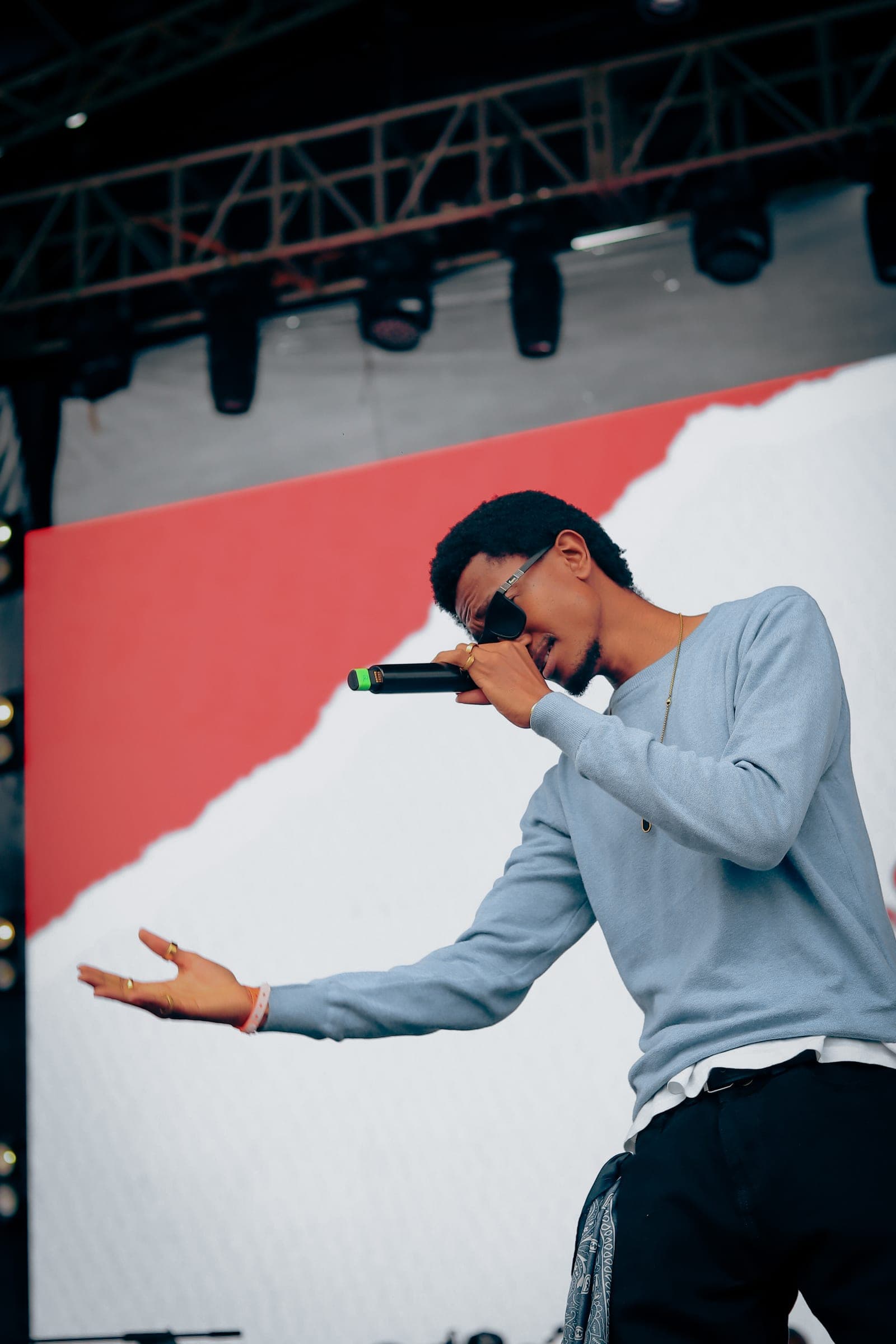 Performer gesturing to the crowd with a microphone